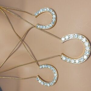 Layered gold-tone necklace with rhinestone horseshoe pendants